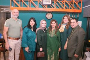 Rotary South Karachi members and guests pose during the green-themed weekly fellowship dinner.