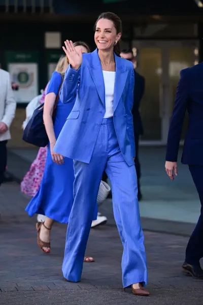 Kate Middleton, Princess of Wales, wearing a blue suit during her visit to Wimbledon at the All England Lawn Tennis and Croquet Club.