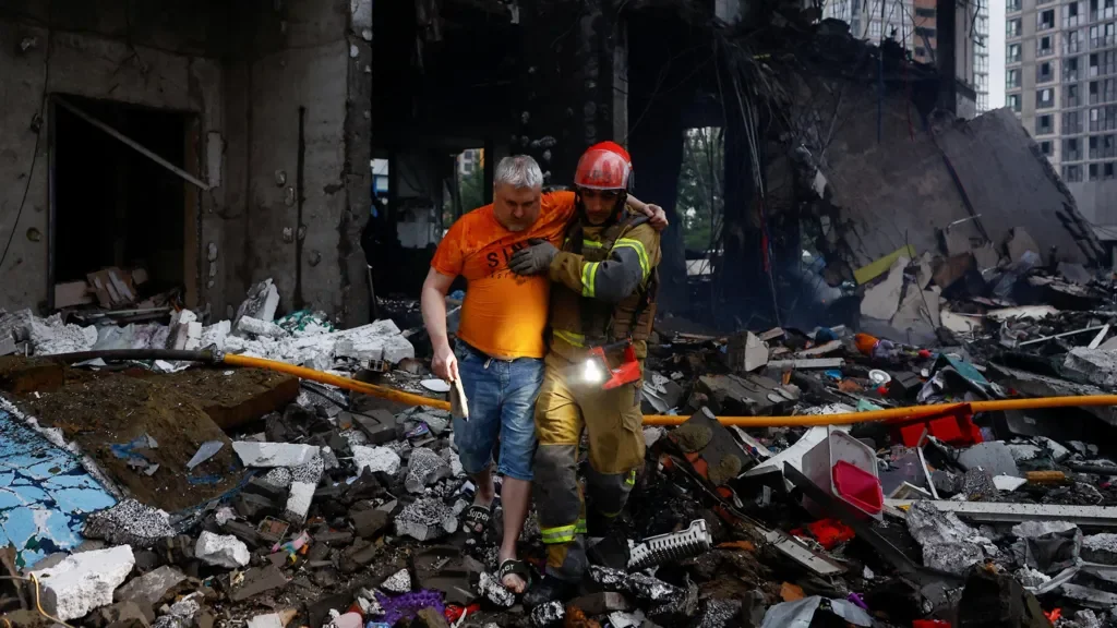 Rescue workers search through the rubble of damaged apartment buildings following Russian missile strikes in Kyiv, Ukraine.