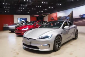 Tesla electric vehicles parked outside a Tesla showroom during a period of rising global sales.