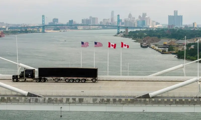 US and Canadian flags representing rising trade tensions and new tariffs