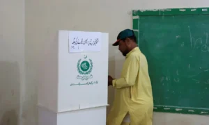 Voters and polling staff at an AJK election polling station in Muzaffarabad.