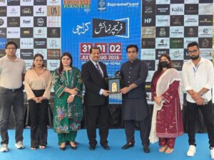 Dr. Mirza Ikhtiar Baig receiving a shield from Mian Faisal Mohsin during the Furniture Expo closing ceremony at Karachi Expo Centre.