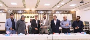 Mustafa Kamal addresses ABAD members during a Karachi ceremony on city funding and development