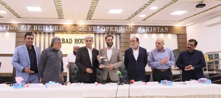 Mustafa Kamal addresses ABAD members during a Karachi ceremony on city funding and development