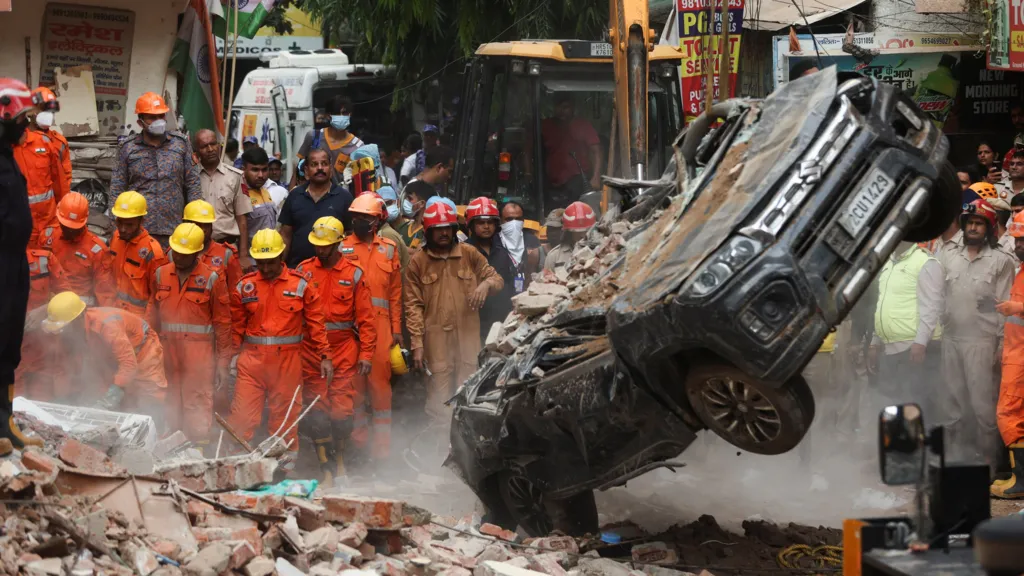 Rescue teams searching rubble after a building collapse in Delhi