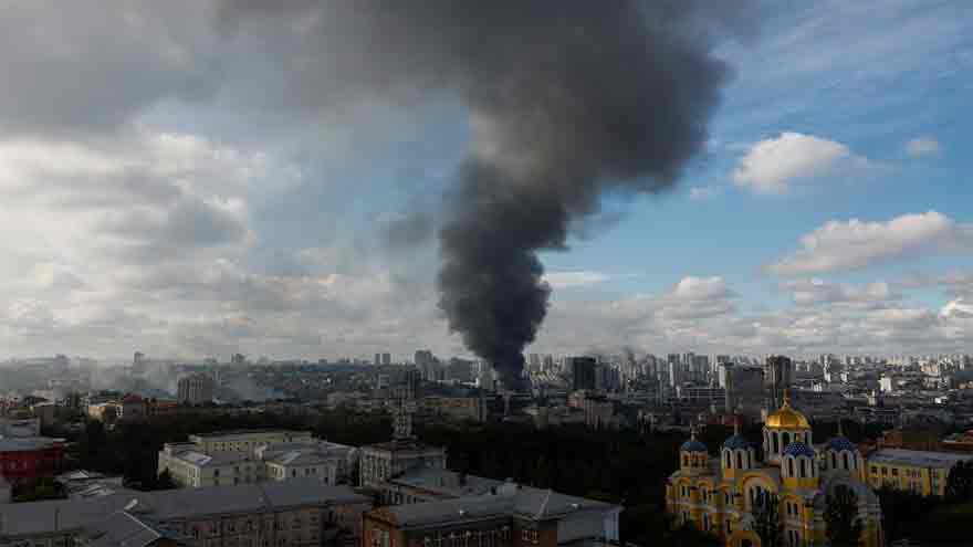 Emergency crews inspect damage after a Russian missile attack on Kyiv