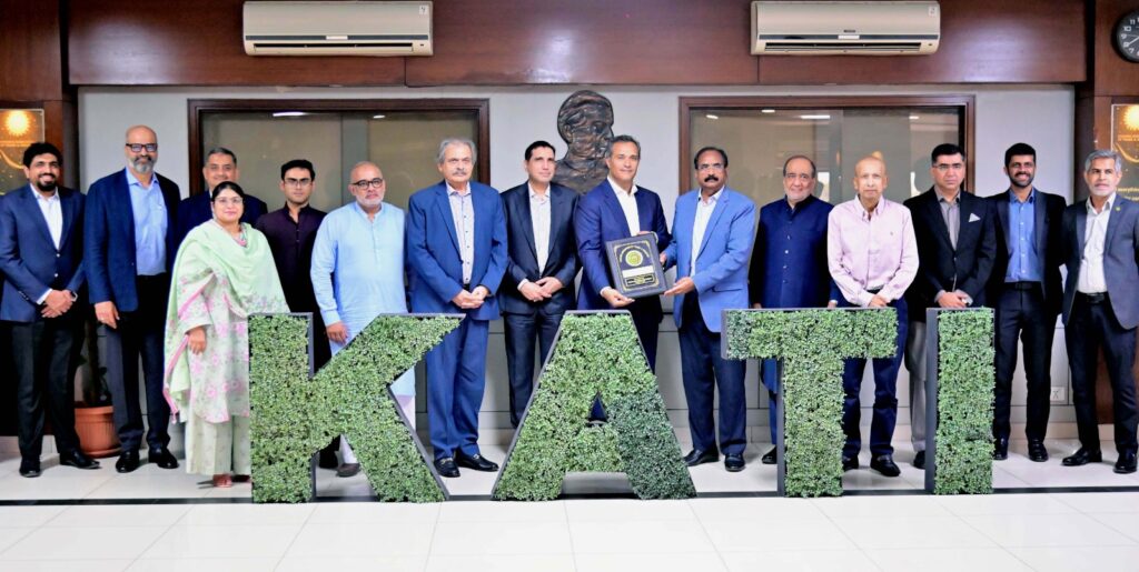 KATI President Muhammad Ikram Rajput presents a shield to K-Electric Board Chairman Shaheryar Chishti