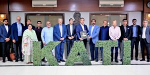 KATI President Muhammad Ikram Rajput presents a shield to K-Electric Board Chairman Shaheryar Chishti