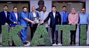 KATI President Muhammad Ikram Rajput presents a shield to Sindh Labour Secretary Sajid Jamal Abro.