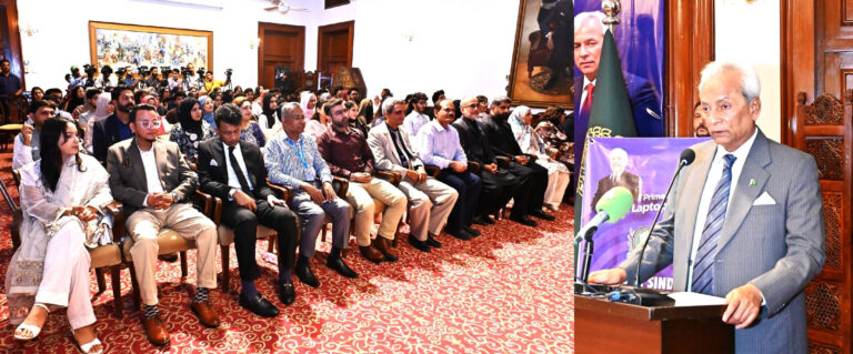 Governor Sindh Nehal Hashmi distributes laptops to students at the PM Youth Programme ceremony in Karachi.