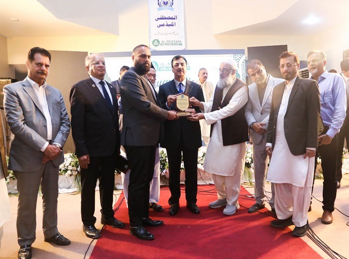 Yousaf Raza Gilani presents crest to Abdul Hadi at My Home Al-Mustafa Orphanage in Karachi