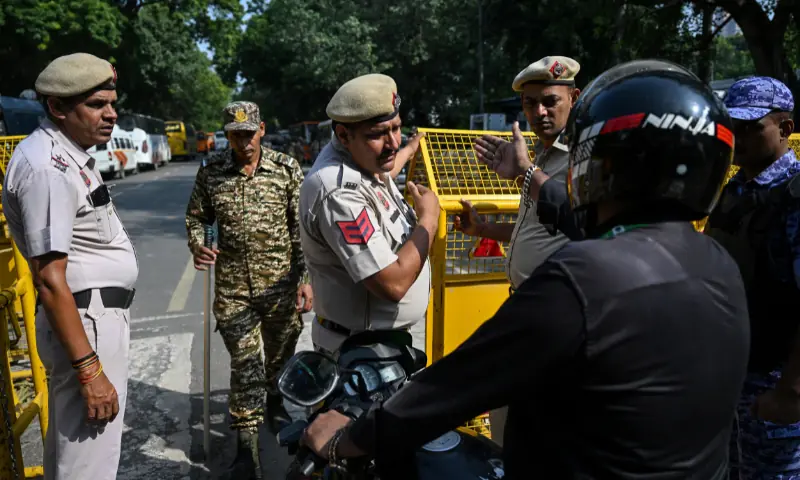 Protesters climb over barricades at Jantar Mantar in New Delhi before police detain Cockroach Janta Party leaders