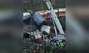 Spain Train Crash site near Urda showing damaged high-speed train carriages and emergency response teams.