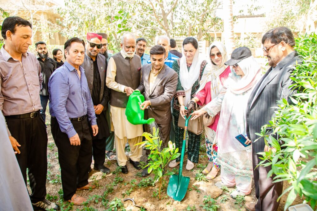 Students and teachers plant trees during a Fajr Fatima Welfare Trust environmental campaign at Government Delhi College in Karachi.
