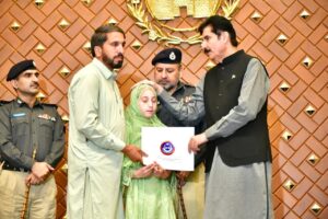 KP Governor Faisal Karim Kundi distributes plot allotment letters to families of 54 police martyrs at Governor House Peshawar