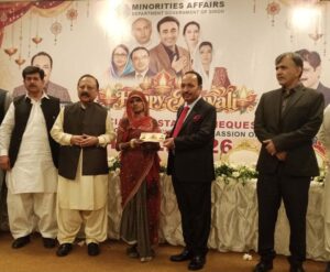 Dr Sham Sunder Advani at a Diwali celebration where financial assistance cheques were distributed to deserving minority families.