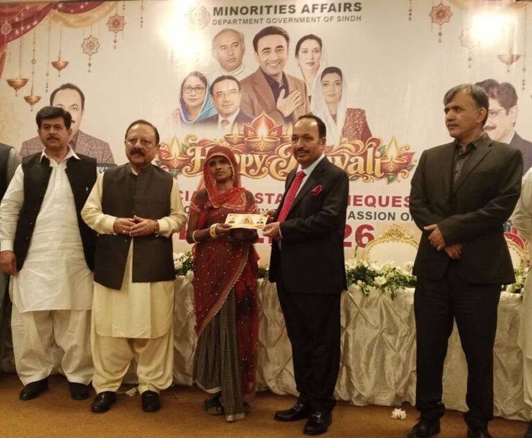 Dr Sham Sunder Advani at a Diwali celebration where financial assistance cheques were distributed to deserving minority families.